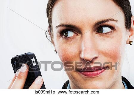 Young woman holding smartphone View Large Photo Image Stock Photography - Young woman holding smartphone. Fotosearch