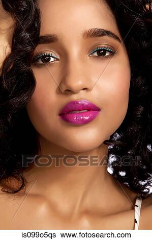 Stock Photograph - Young woman in close up against white background. Fotosearch