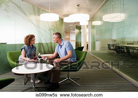 Young woman in discussion with mature man about wind turbines View Large Photo Image Stock Photograph - Young woman in discussion with mature man about wind turbines. Fotosearch