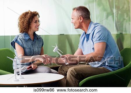 Young woman in meeting with mature man about wind turbine View Large Photo Image Stock Photograph - Young woman in meeting with mature man about wind turbine. Fotosearch