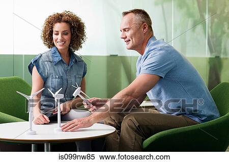 Young woman in meeting with mature man about wind turbine View Large Photo Image Stock Photography - Young woman in meeting with mature man about wind turbine. Fotosearch