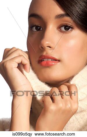 Young woman in polo neck against white background View Large Photo Image Stock Photo - Young woman in polo neck against white background. Fotosearch