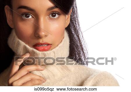 Young woman in polo neck against white background View Large Photo Image Stock Photo - Young woman in polo neck against white background. Fotosearch