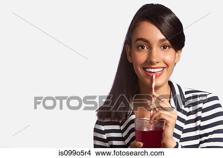 Young woman in striped top drinking from straw against white background View Large Photo Image Picture - Young woman in striped top drinking from straw against white background. Fotosearch