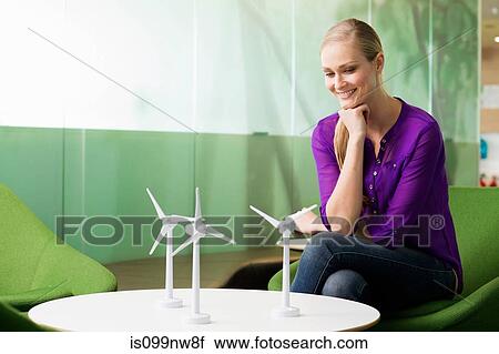 Young woman looking at model of wind turbine View Large Photo Image Stock Image - Young woman looking at model of wind turbine. Fotosearch