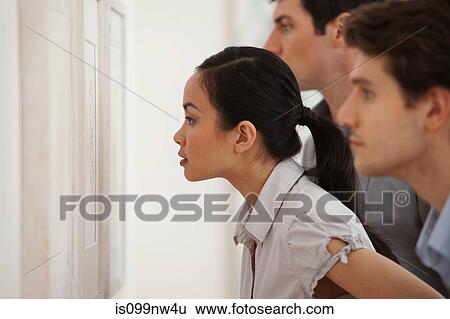 Young woman looking at picture in art gallery View Large Photo Image Stock Photograph - Young woman looking at picture in art gallery. Fotosearch