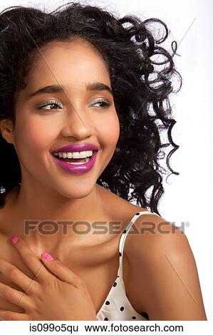 Young woman looking away and smiling against white background View Large Photo Image Stock Photograph - Young woman looking away and smiling against white background. Fotosearch