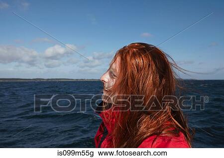 Stock Image - Young woman sailing, portrait. Fotosearch
