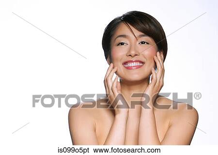 Young woman smiling against white background View Large Photo Image Stock Photograph - Young woman smiling against white background. Fotosearch