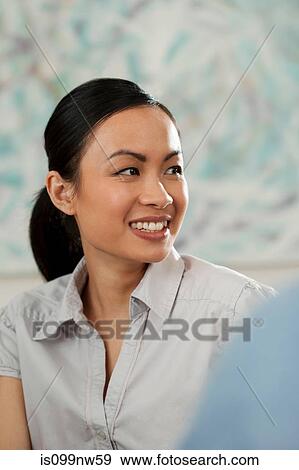 Young woman smiling and looking away in gallery View Large Photo Image Stock Photo - Young woman smiling and looking away in gallery. Fotosearch