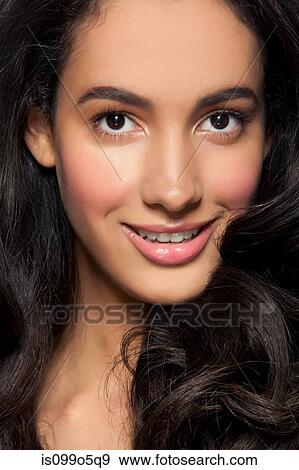 Stock Photo - Young woman smiling, close up. Fotosearch