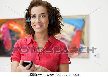 Young woman using audio guide in art gallery View Large Photo Image Picture - Young woman using audio guide in art gallery. Fotosearch