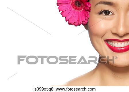 Stock Photo - Young woman wearing pink flower in hair against white background. Fotosearch