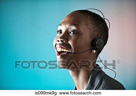 Young woman wearing telephone headset, laughing View Large Photo Image Stock Image - Young woman wearing telephone headset, laughing. Fotosearch