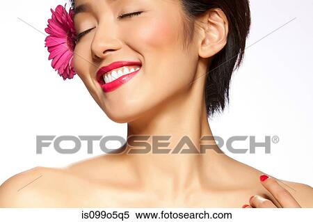 Stock Photography - Young woman with closed eyes against white background. Fotosearch