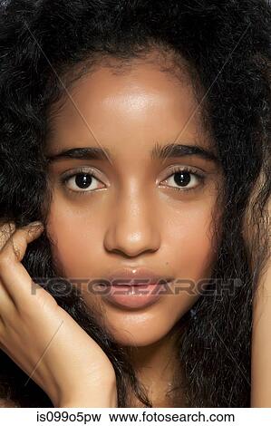 Young woman with hands in hair, close up, portrait View Large Photo Image Stock Photo - Young woman with hands in hair, close up, portrait. Fotosearch