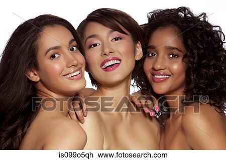 Stock Image - Young women smiling together against white background. Fotosearch
