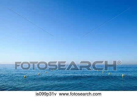 Blue sky and ocean with row of buoys View Large Photo Image Stock Photo - Blue sky and ocean with row of buoys. Fotosearch