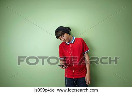 Boy listening to mp3 player View Large Photo Image Stock Image - Boy listening to mp3 player. Fotosearch