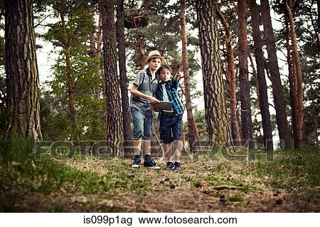 Boys with digital tablet in forest View Large Photo Image Stock Image - Boys with digital tablet in forest. Fotosearch
