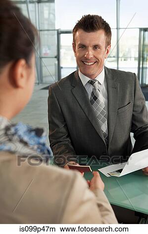 Businessman checking in at airport View Large Photo Image Picture - Businessman checking in at airport. Fotosearch