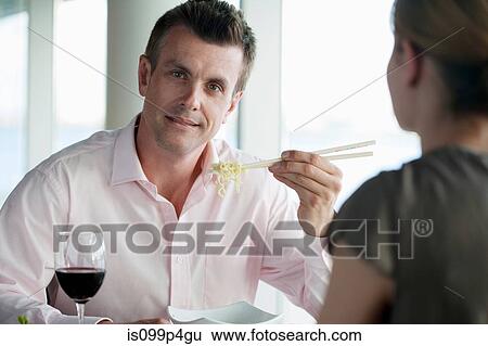 Businessman eating noodles View Large Photo Image Stock Photograph - Businessman eating noodles. Fotosearch