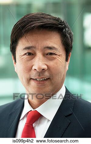 Stock Image - Businessman looking at camera, portrait. Fotosearch