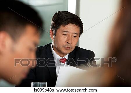 Stock Photograph - Businessman reading document. Fotosearch