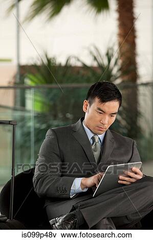 Stock Photo - Businessman with digital tablet. Fotosearch