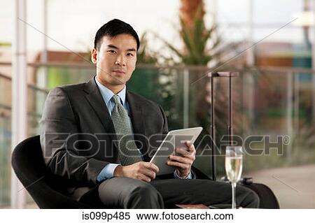 Stock Photography - Businessman with digital tablet, portrait. Fotosearch