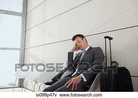 Businessman with luggage, sleeping View Large Photo Image Stock Photo - Businessman with luggage, sleeping. Fotosearch