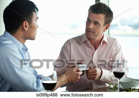 Businessmen exchanging business cards View Large Photo Image Stock Photo - Businessmen exchanging business cards. Fotosearch