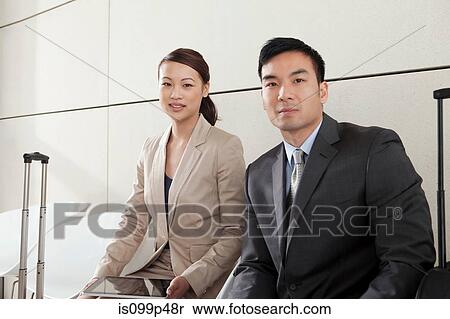 Stock Photography - Businesspeople with luggage, portrait. Fotosearch