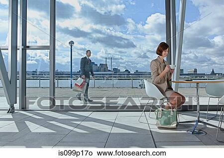 Businesswoman drinking coffee in airport View Large Photo Image Picture - Businesswoman drinking coffee in airport. Fotosearch