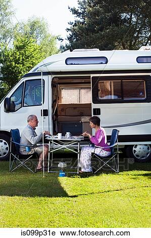 Couple eating breakfast outside campervan View Large Photo Image Stock Image - Couple eating breakfast outside campervan. Fotosearch