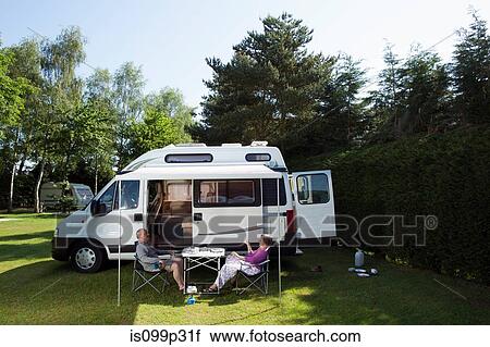 Couple eating breakfast outside campervan View Large Photo Image Stock Image - Couple eating breakfast outside campervan. Fotosearch