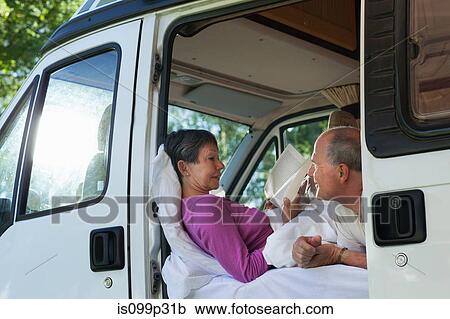 Couple in campervan, woman reading View Large Photo Image Stock Image - Couple in campervan, woman reading. Fotosearch