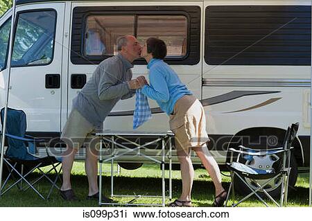 Couple kissing outside campervan View Large Photo Image Stock Image - Couple kissing outside campervan. Fotosearch
