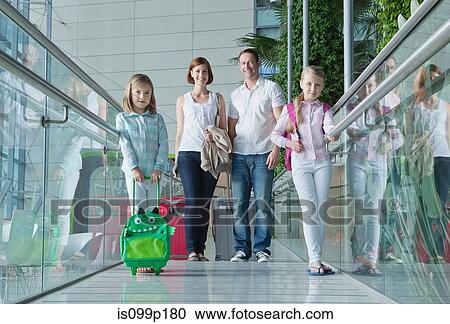 Family in airport with luggage View Large Photo Image Stock Image - Family in airport with luggage. Fotosearch