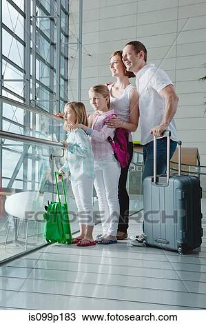Family in airport with luggage View Large Photo Image Stock Image - Family in airport with luggage. Fotosearch