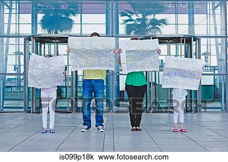 Family with maps outside airport View Large Photo Image Stock Image - Family with maps outside airport. Fotosearch