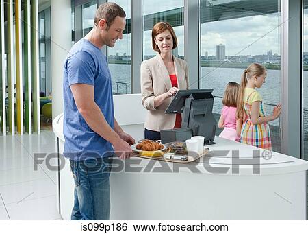 Stock Photograph - Father with two daughters in airport cafe. Fotosearch