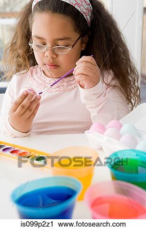 Girl painting an egg for easter View Large Photo Image Stock Image - Girl painting an egg for easter. Fotosearch