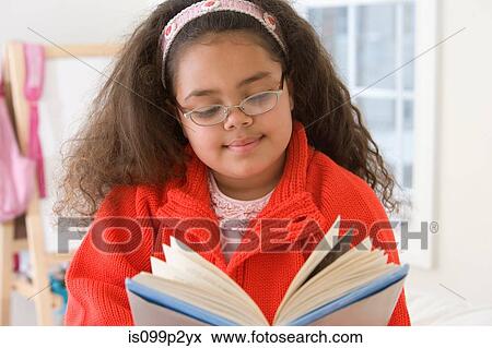 Girl reading a book at school View Large Photo Image Stock Photo - Girl reading a book at school. Fotosearch