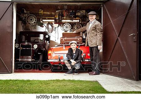 Grandfather and grandson with vintage car and trunk suitcases in garage View Large Photo Image Picture - Grandfather and grandson with vintage car and trunk suitcases in garage. Fotosearch