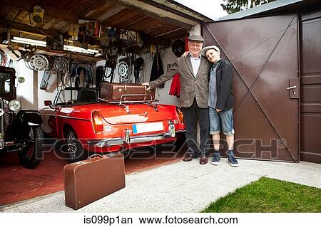 Grandfather and grandson with vintage car and trunk suitcases in garage View Large Photo Image Picture - Grandfather and grandson with vintage car and trunk suitcases in garage. Fotosearch