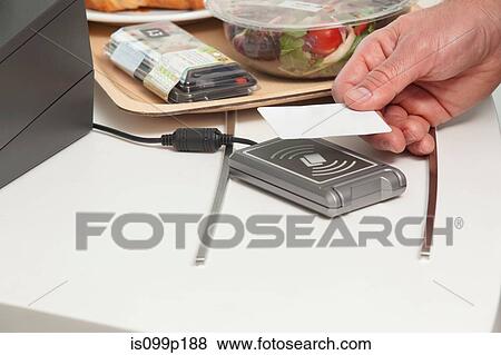 Man using card to buy food View Large Photo Image Stock Photo - Man using card to buy food. Fotosearch