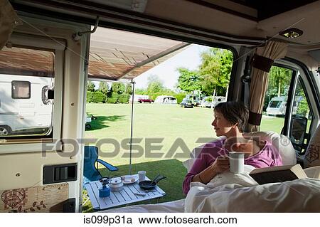 Mature woman reading in camper van View Large Photo Image Stock Image - Mature woman reading in camper van. Fotosearch