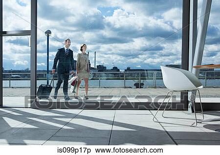 Stock Photography - Mid adult couple in airport. Fotosearch