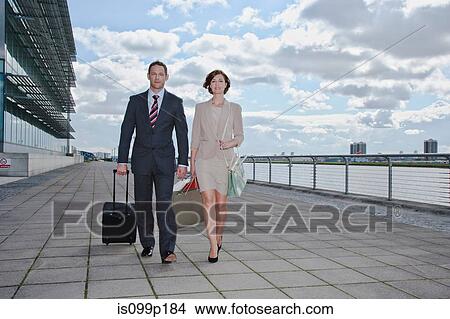 Picture - Mid adult couple outside airport. Fotosearch
